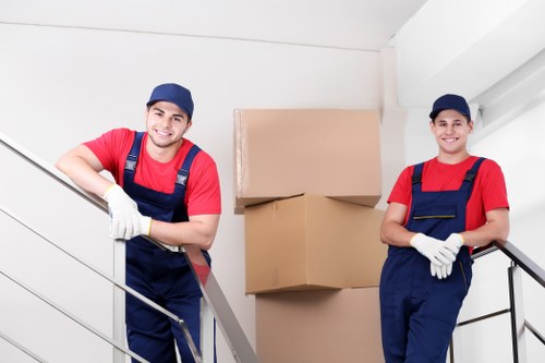 Team planning office removals in Twickenham with moving boxes and desks